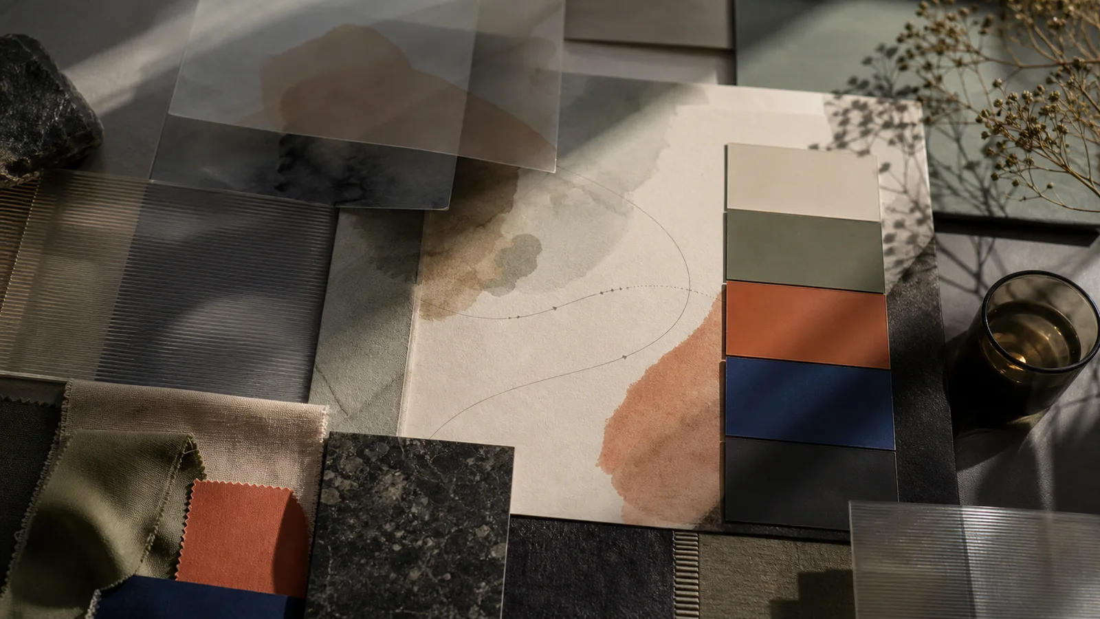 Muted color swatches, material samples, and brand palette cards arranged like a weather map